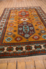 Vintage Siberian Kazak rug fringe and ivory pawn design border with floral motifs.