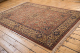 Hand knotted Romanian Tabriz rug corner, dark beige field, ivory border, and navy palmettes.