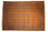 Fine Pakistani Bokhara carpet with repeating gul medallions on a bright tangerine orange field.
