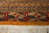 Plush tangerine border and original ivory fringe with light tinting on a vintage Bokhara rug.