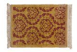 Saffron yellow and raspberry red vintage Indian Damask rug mat with embossed floral pattern.
