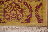 Embossed raspberry red and saffron yellow Damask pattern corner with ivory fringe.