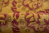 Textured pile showing embossed raspberry red and saffron yellow curvilinear Damask floral motifs.