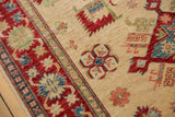 Ivory field with cherry red border and sky blue, green geometric floral motifs.