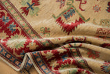 Hand-knotted pile texture on ivory field with cherry red, blue, green floral cross-sections.