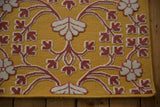 Reverse Soumac weave with raised cochineal red and ivory floral motifs on a saffron yellow flatweave.