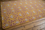The repeating floral pattern of a Samarkand design carpet shown from a high angle, highlighting the raised texture.