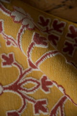 Unique mixed texture of raised ivory and red pile on a saffron yellow flatweave.