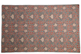 Samarkand design carpet with scrolling floral petals in cochineal red and ivory over a silver-grey field.