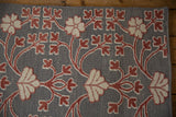 The mixed reverse Soumac and hand-knotted pile weave in silver, red, and ivory.