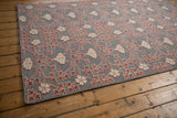The distinctive raised pile of floral motifs on the silver-grey flatweave of a Samarkand carpet.