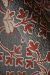The unique reverse Soumac weave showing raised cochineal red pile over a silver flatweave base.