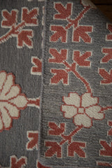 Detail showing the mixed texture of raised floral pile on the silver Soumac flatweave.