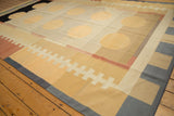 Abstract geometric detail of the vintage kilim, featuring pale yellow circles and ivory ladder pattern.