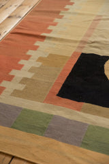 Abstract kilim's geometric stepped pattern with abrashed blush, beige, khaki, and black.