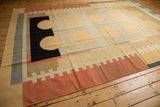 Contemporary kilim rug with abstract double circles and banded rectangles. Ivory, black, faded red.