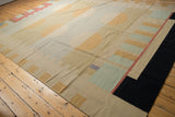 Vintage Contemporary Kilim rug corner with geometric beige, powder blue, black, and red elements.