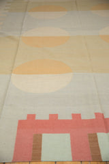 Vintage contemporary kilim with splayed circles and abstract geometric patterns in beige, blue, and red.