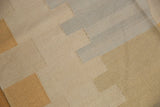 Contemporary Kilim rug's flatweave texture with interlocking beige, sand, and powder blue shapes.