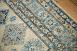 Close-up of the stepped contour and geometric medallions of a hand-knotted Pakistani Kazak rug.