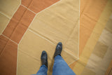 Hand woven vintage Kilim, showing argyle geometric design in terracotta, gold, and beige.