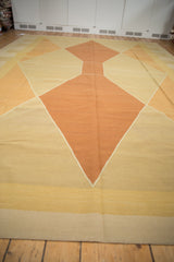 Contemporary Indian kilim rug with argyle-inspired diamond patterns in terracotta, gold, and ivory.