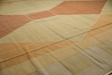 Hand-woven vintage Kilim carpet detail, modern Argyle pattern in soft ivory, sand, and copper.