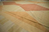 Softly saturated geometric flatweave on the contemporary Kilim in beige and copper tones.