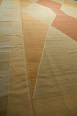 Kilim carpet detail showing modern argyle-inspired design with ivory, sand, and copper abrash.