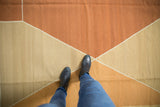 Contemporary geometric diamond pattern in dark copper, sand, and dusty ivory.