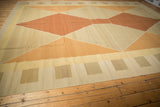 Detail of contemporary Kilim carpet border, beige, sand, and gold geometric blocks.