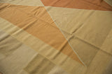 Modern style hand-woven Kilim rug, showcasing argyle diamond pattern in beige and copper.