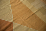 Hand woven Kilim rug detail, showing Argyle diamond pattern in copper, ivory, and beige.