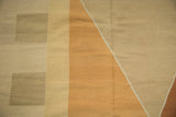 Close-up of hand woven contemporary Kilim carpet, geometric beige blocks and copper triangle.