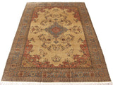 Corner detail of vintage Tabriz rug, showing dusty blue floral border and ivory field with sprays.