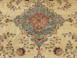 Dusty rose and slate blue curvilinear floral sprays bordering the central medallion of this vintage Tabriz design carpet.