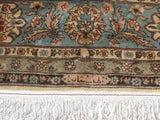 Vintage Romanian Tabriz design rug border with dusty blue, rose florals, cartouche, and ivory fringe.