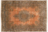 A vintage Cyrus Crown Kerman carpet with an ornate starburst medallion on a rose field with pale blue and indigo scrolling borders.