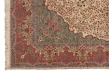 Corner of a vintage Kerman carpet showing the millefleur field and dusty rose floral border.