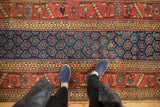 Antique Kurdish runner: repeating boteh motif on navy field with wide terra cotta border.