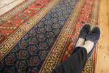 Navy boteh pattern, wide terra cotta main border, late 19th century Kurdish runner.