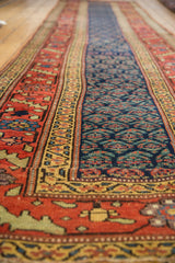 Antique Kurdish runner detail: navy boteh field, wide terra cotta and aubergine border.