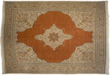 Vintage Tabriz carpet with a starburst medallion and floral spandrels on a terra cotta field with blue and ivory accents.