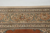 Intricate floral border and original selvage of a hand-knotted vintage Persian Tabriz rug.