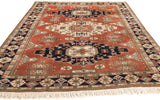 Vintage Meshkin carpet corner with geometric border, copper field, and ivory fringe.