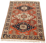 Vintage Persian Meshkin carpet corner with dark navy geometric border and ivory fringe.