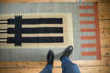 Contemporary Kilim runner with geometric stepped blocks in black, beige, terra cotta.