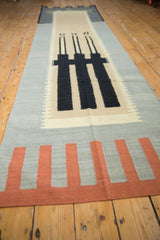 Contemporary Kilim runner's abstract architectural geometric pattern in black, silver, and terra cotta.