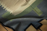 Contemporary Kilim runner's folded corner, featuring abstract charcoal, sage, and coffee geometric blocks.