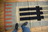 Left side of vintage Kilim runner, terra cotta architectural geometric blocks on pale green.